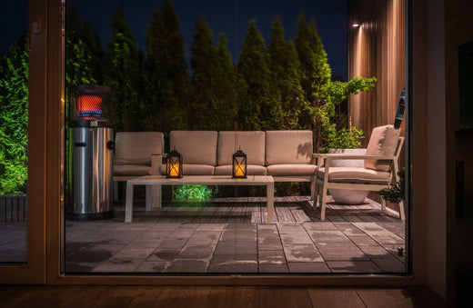 Cozy backyard patio with lanterns at night