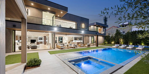 Modern luxury home with pool at dusk