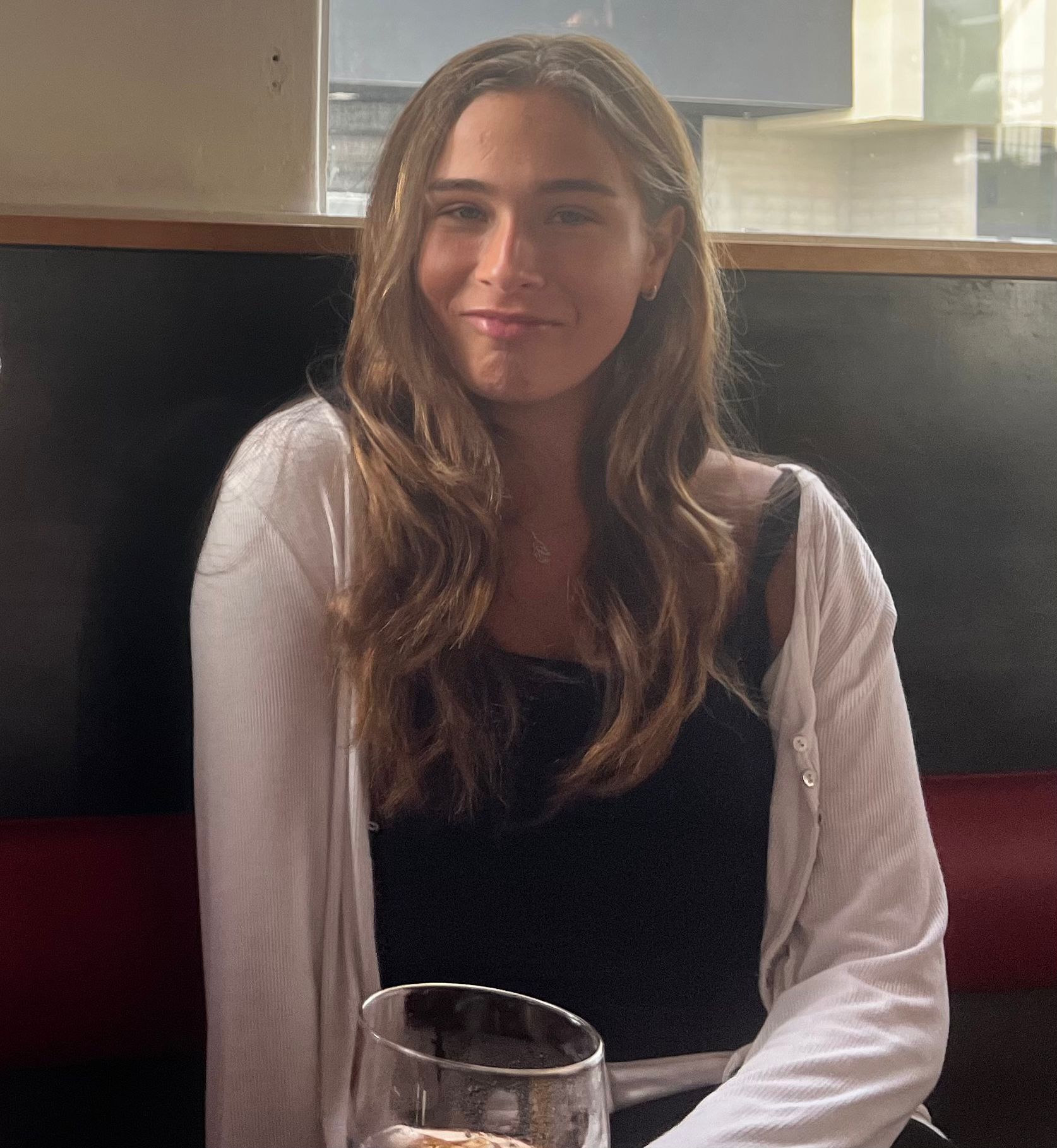 Woman smiling at restaurant table indoors