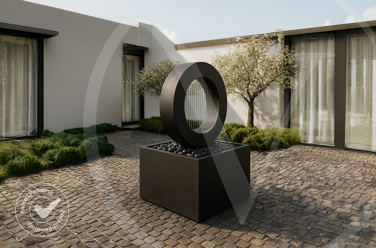 Modern black outdoor planter fountain with a rain curtain and square basin in a minimalist courtyard garden with clipped shrubs and cobblestone paving.