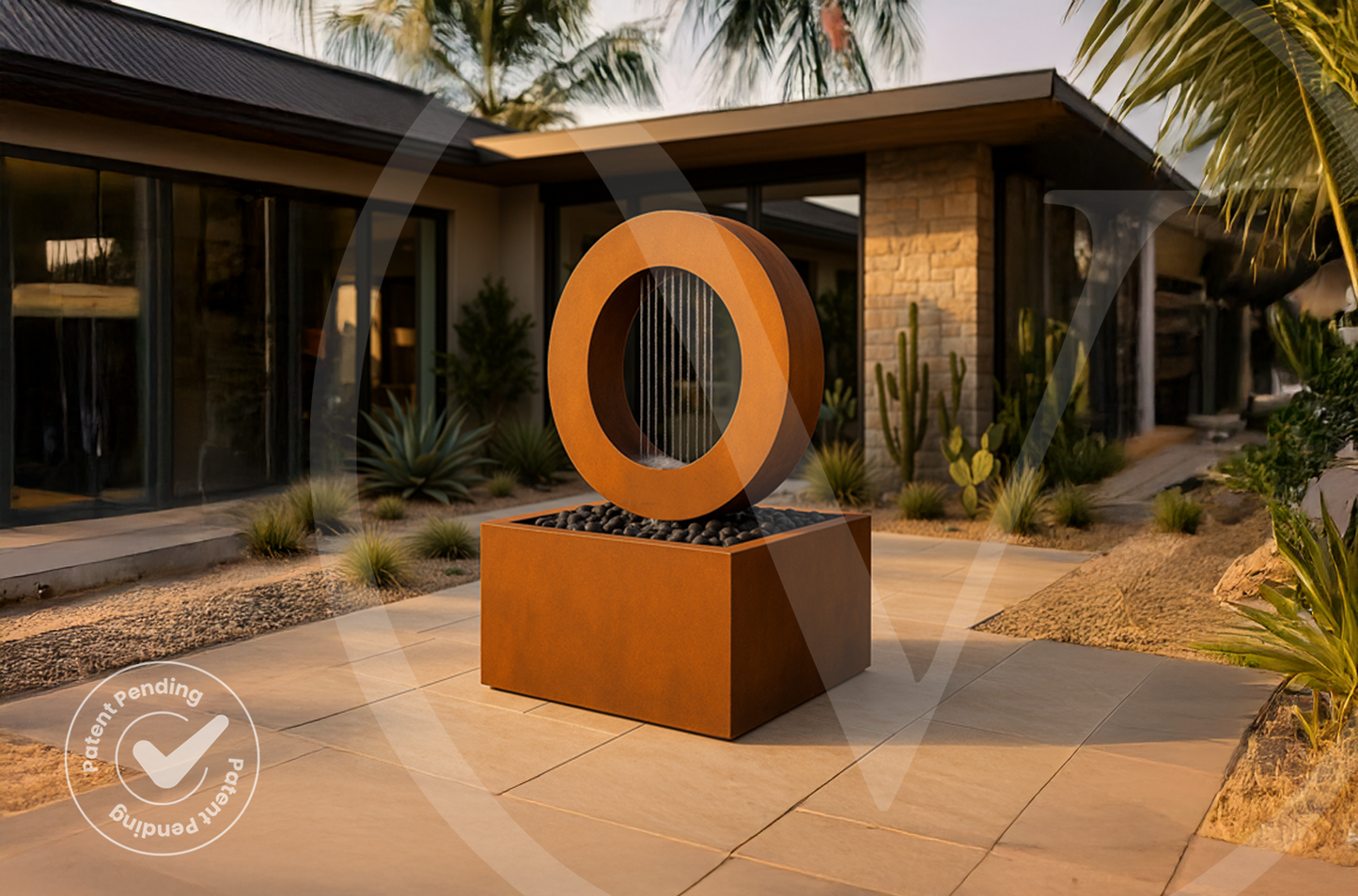 Corten steel rain curtain outdoor planter fountain with a rectangular basin on a patio outside a mid-century modern desert home with cactus landscaping.